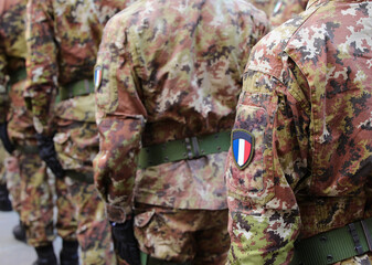 french army soldier in green and brown camouflage uniform with the flag of France