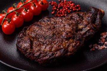 Delicious juicy beef ribeye steak grilled with salt, spices and herbs