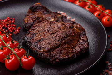Delicious juicy beef ribeye steak grilled with salt, spices and herbs