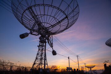 low angle of abandoned telescopes with colorful sunset sky, universe science, explore outer space