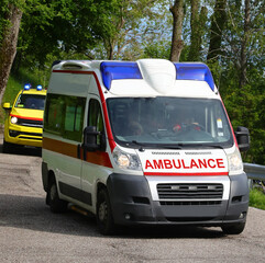 emergency ambulance van with its blue lights flashing while responding to an emergency on the road