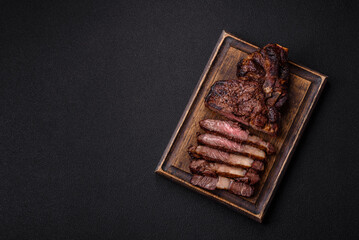 Delicious juicy beef ribeye steak grilled with salt, spices and herbs