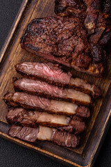 Delicious juicy beef ribeye steak grilled with salt, spices and herbs