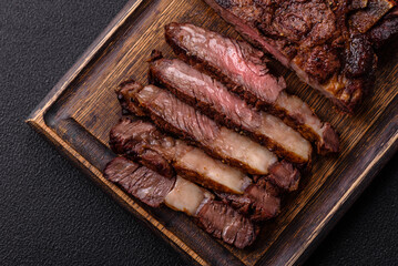 Delicious juicy beef ribeye steak grilled with salt, spices and herbs