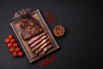 Delicious juicy beef ribeye steak grilled with salt, spices and herbs