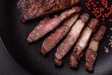 Delicious juicy beef ribeye steak grilled with salt, spices and herbs