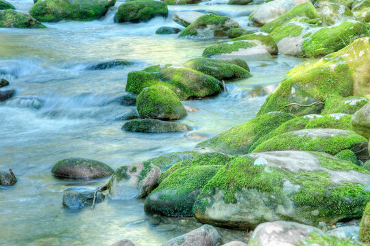 River flowing through mossy rocks