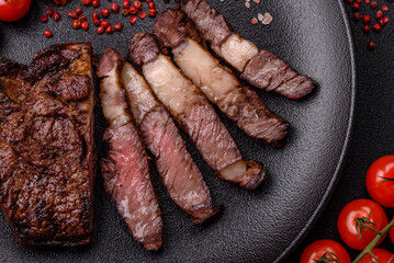 Delicious juicy beef ribeye steak grilled with salt, spices and herbs