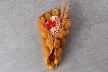 Delicious sweet bubble waffle on table