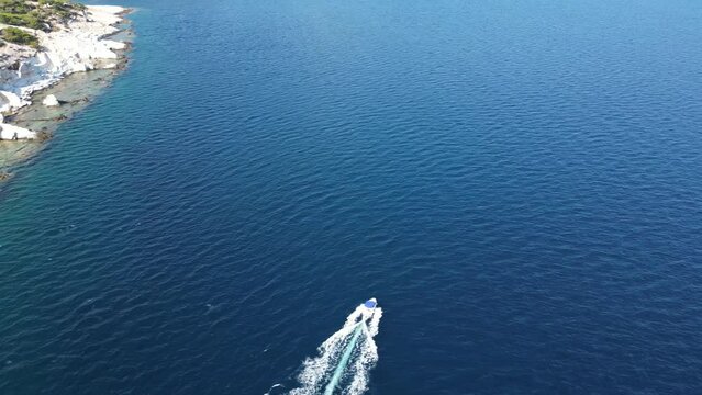 Aerial view of the scenic Aliki quarry as a speed boat passes by in Thassos, Greece