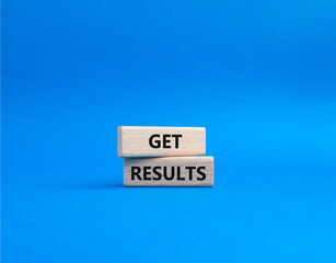 Get results symbol. Wooden blocks with words Get results. Beautiful blue background. Business and...