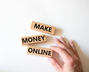 Make Money Online symbol. Concept words Make Money Online on wooden blocks. Businessman hand. Beautiful white background. Business and Make Money Online concept. Copy space.