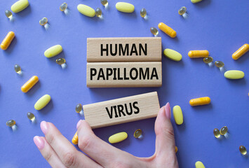 Human Papilloma Virus symbol. Concept word Human Papilloma Virus on wooden blocks. Doctor hand....