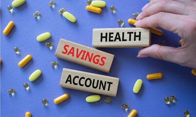 Health Saving Account symbol. Concept word Health Saving Account on wooden blocks. Doctor hand....