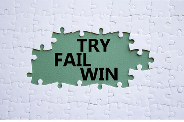 Try Fail Win symbol. Concept words Try Fail Win on white puzzle. Beautiful grey green background....