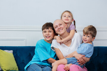 Mother after chemotherapy treatment is laughing with her kids