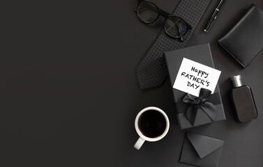 Fathers day background with gift box, necktie, glasses on black. Happy Fathers Day greeting card design.