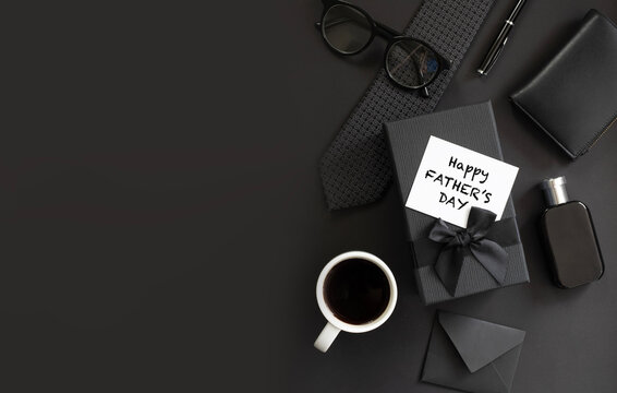 Fathers day background with gift box, necktie, glasses on black. Happy Fathers Day greeting card design.