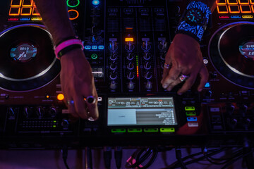 DJ hands making music mixes to liven up the party. Concept: electronic music, bollywood