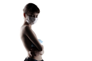 Elegant young woman with medical face mask, holding masks against white background