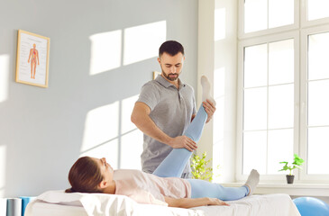 Skilled rehabilitation therapist provides specialized physiotherapy to a female patient at a...