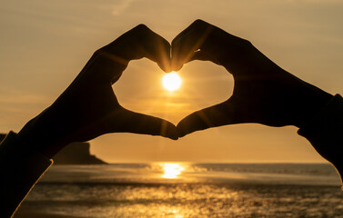 Hand Heart on a Beach at Sunrise or Sunset