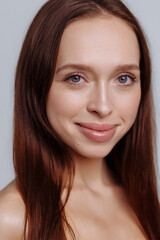 Fototapeta premium Close-up portrait of yong woman casual portrait in positive view, big smile, beautiful model posing in studio over white background. Caucasian portrait woman.