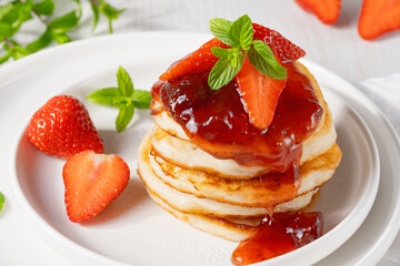 Mini pancakes with strawberry jam and strawberries