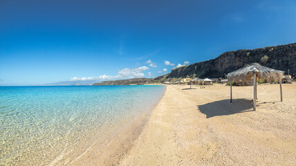 Sable Blanc sand beach with straw roofed huts and turquoise sea, Tajourah region, Djibouti, Horn of Africa