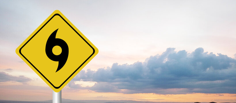 Hurricane season with symbol sign against a stormy background and copy space. dirty and angled sign adds to the drama. hurricane sign, hurricane season sing on cloudy background