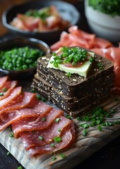 Pumpernickel - Dark, dense rye bread with a side of butter and ham.