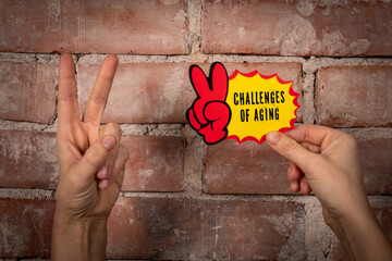 Challenges of aging. Sticky note with text on a red brick background