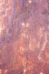 Rusty metal background with streaks of rust. Rust stains. The metal surface rusted spots. Rusty corrosion. Vertical.