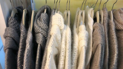 Winter clothing on display at store, hanging on hangers