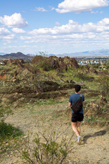 Fototapeta premium Woman taking a short hike on a mountain at Phoenix Mountain Preserve