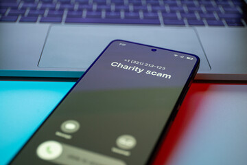 Charity Scam call concept on mobile phone. Person get scam call alert. Phone call from unknown...