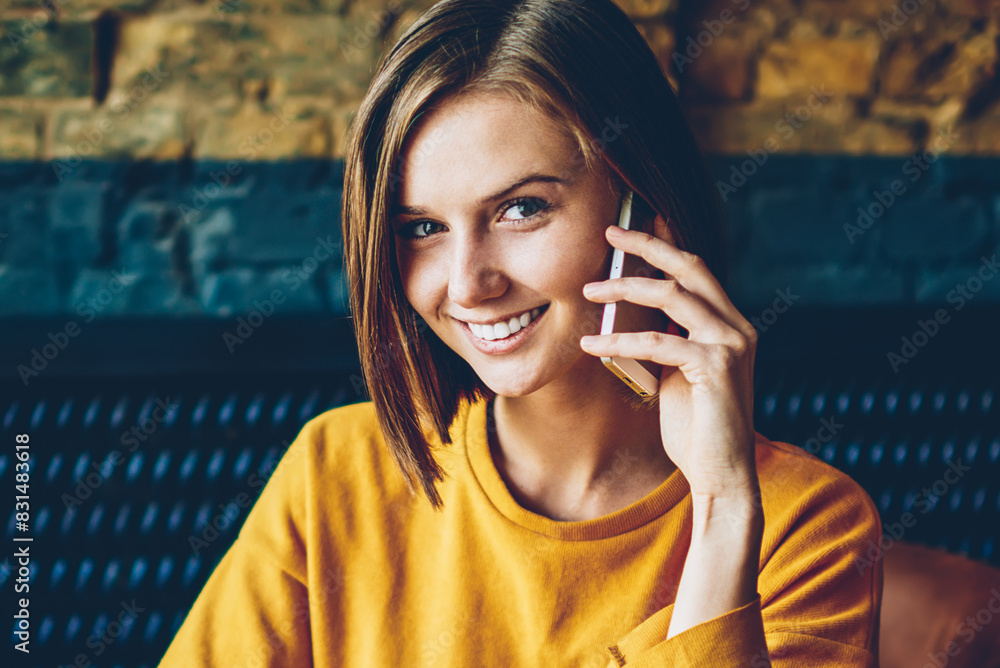 Aufkleber half length portrait of cheerful female manager talking with client on digital telephone working wit