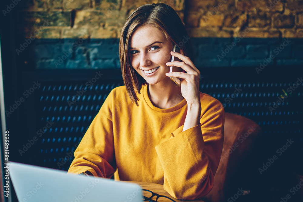 Aufkleber half length portrait of cheerful female manager talking with client on digital telephone working wit