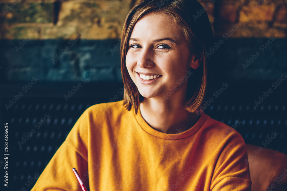 Aufkleber half length portrait of successful skilled student with literature book in hands smiling at camera w