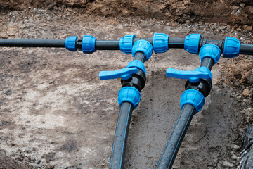 Fragment of a water supply system made of HDPE pipes, installation of automatic watering