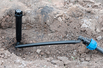 Sprinkler for automatic watering on a flexible connection close-up, the process of installing a...