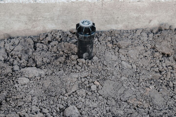 Fototapeta premium Sprinkler for automatic watering on a flexible connection close-up, the process of installing a pipeline from HDPE pipes