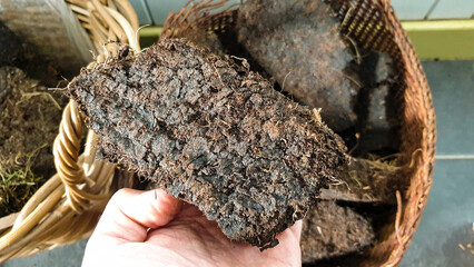 Close up of a dried block of Scottish peat used as fuel in log burner to heat house