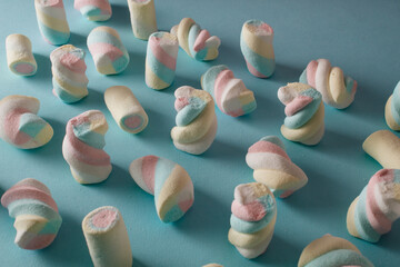 Marshmallows lined up on a blue background.