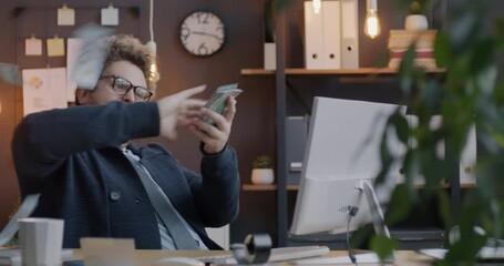 Loop of overjoyed businessman throwing cash money having fun enjoying financial success in office in evening. Business and rich people concept. - Powered by Adobe