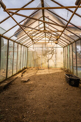 Inside of empty greenhouse, preparing soil in hothouse for sowing