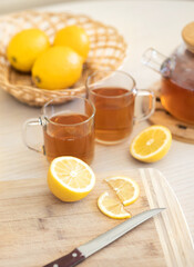 Fresh lemon and lemon tea in wooden dish