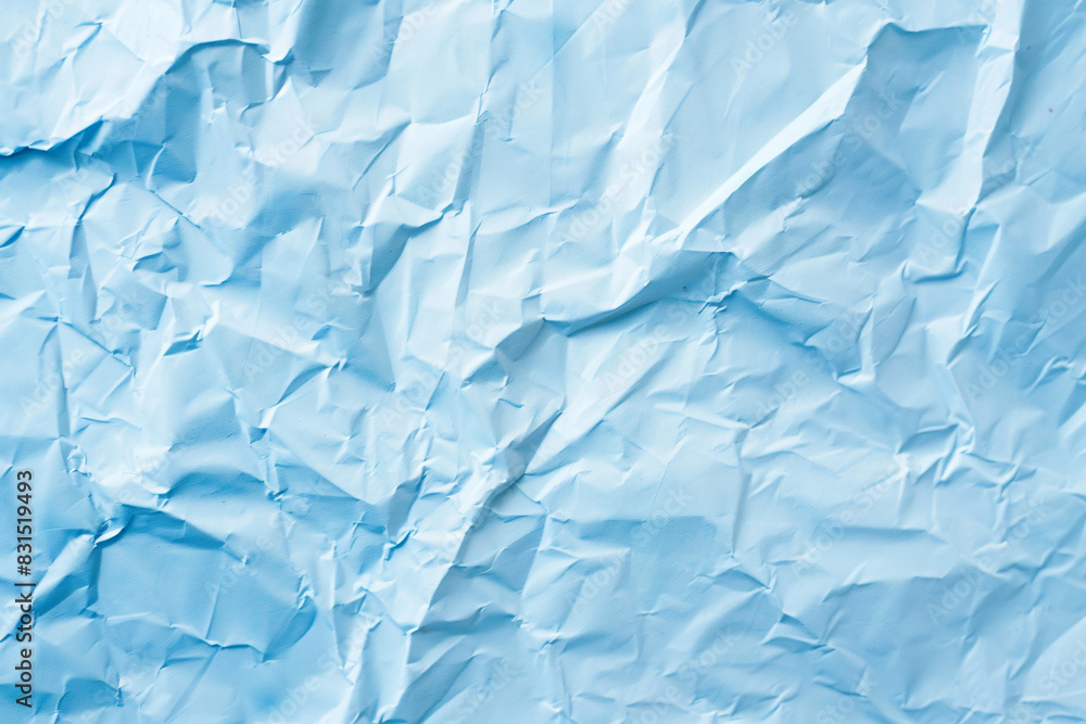 Poster crumpled blue paper with light and shadows creating a textured effect suitable for various designs