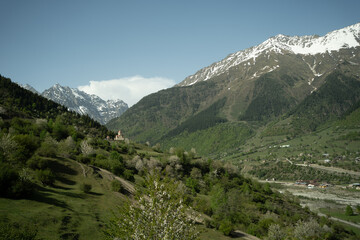 Fototapeta premium Valley with road, surrounded by mountains under a vast sky