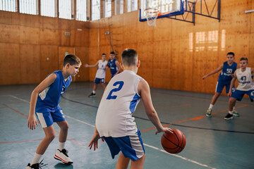 A junior basketball team practicing game play on training.